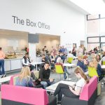 The Box Office, people sitting on chairs and ordering food